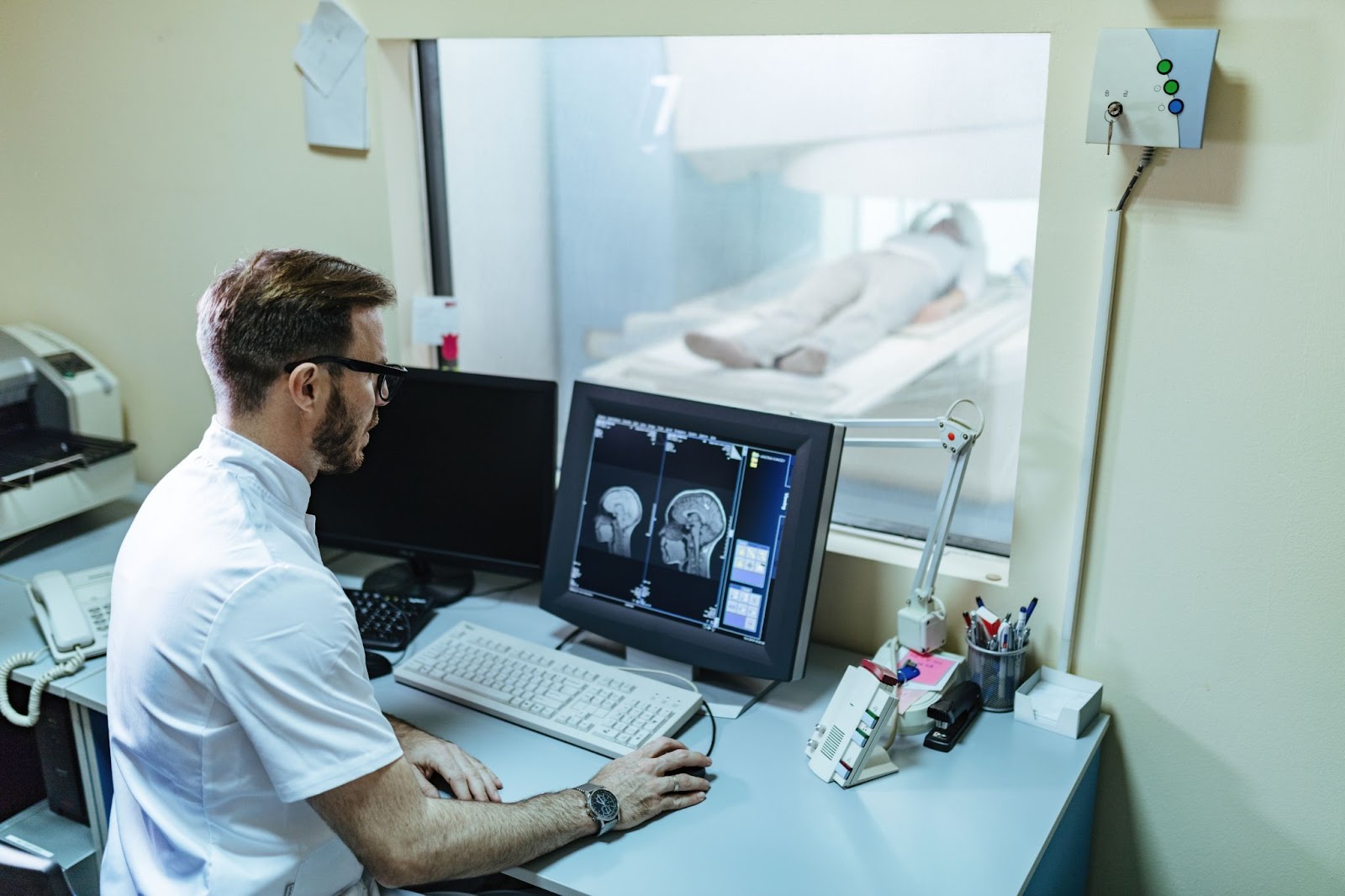 A radiologist analyzes the MRI scan results of a patient on a computer monitor