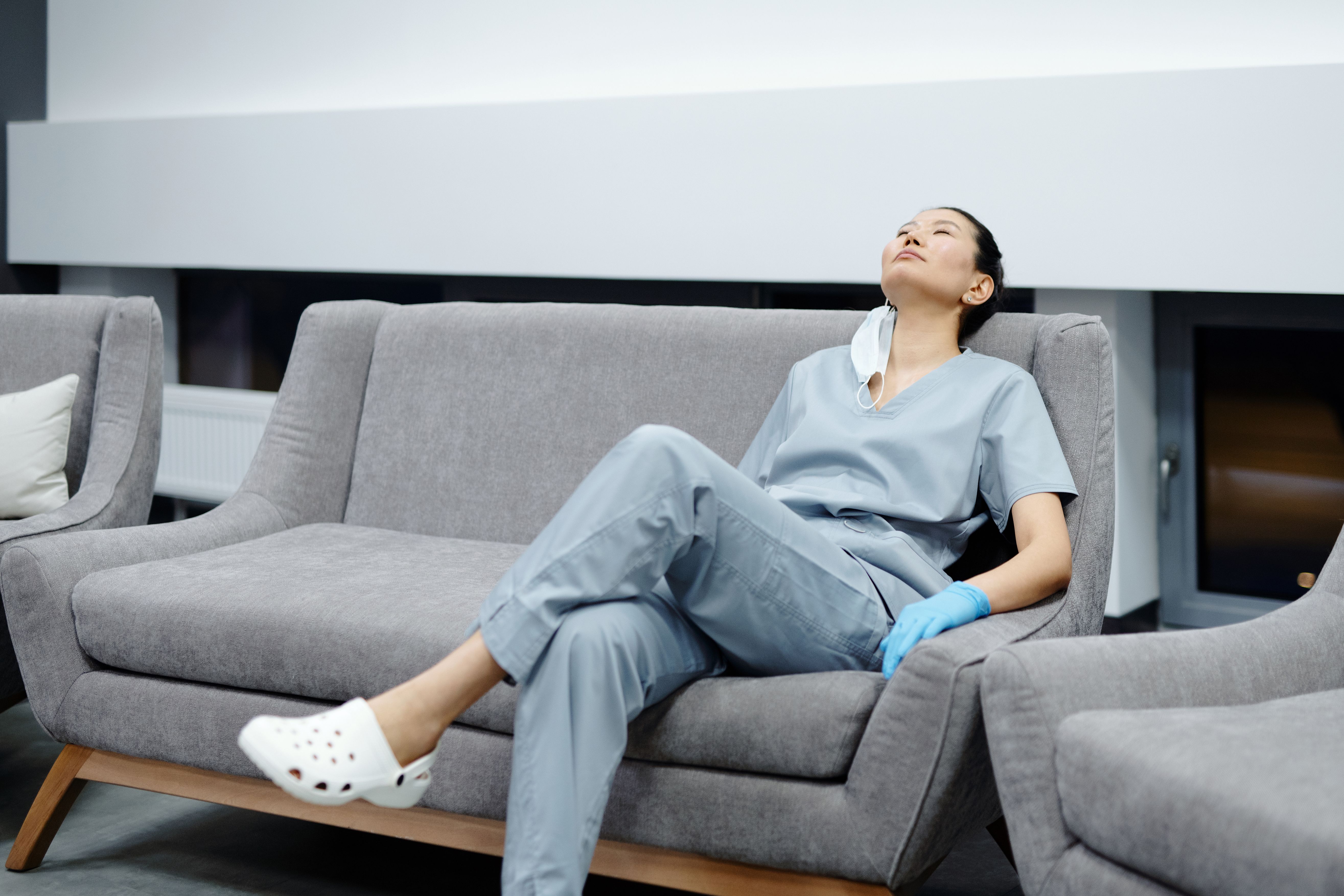 Nurse experiencing alarm fatigue in a clinical setting with multiple monitoring devices