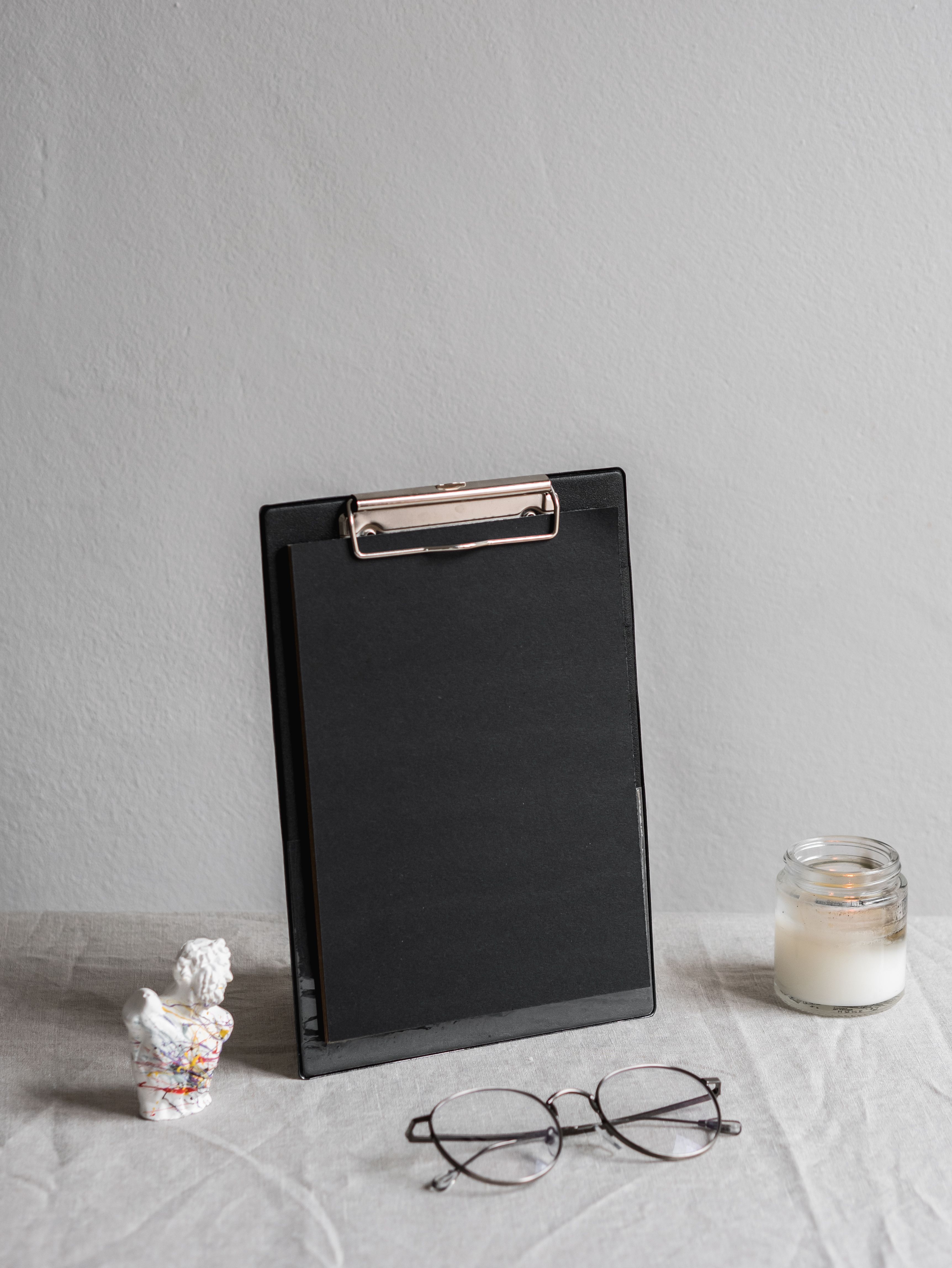 Folding nursing clipboard that closes over handover notes to keep them covered