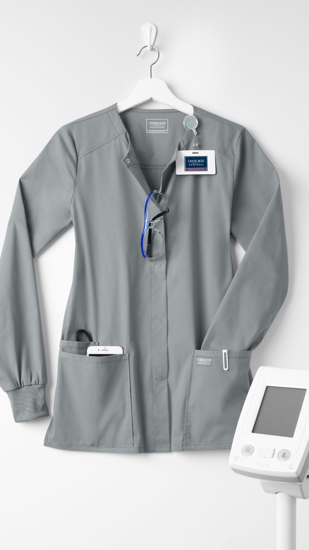 Thermal scrub jacket worn as a warm, uniform-compatible layer on a cold hospital unit